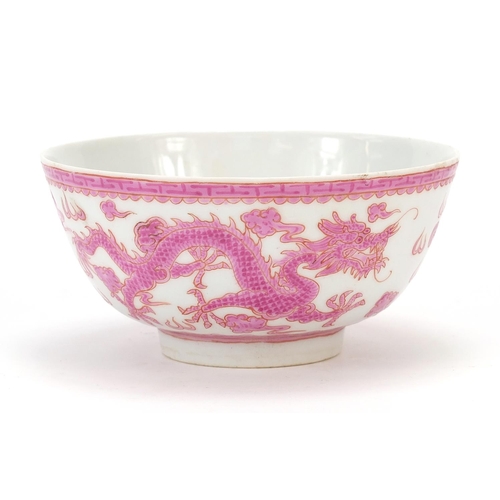 463 - Chinese porcelain bowl hand painted in pink with a dragon and phoenix amongst clouds chasing a flami... 