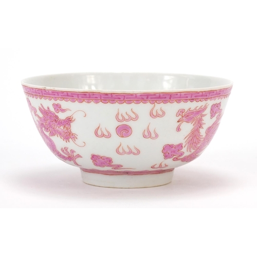 463 - Chinese porcelain bowl hand painted in pink with a dragon and phoenix amongst clouds chasing a flami... 