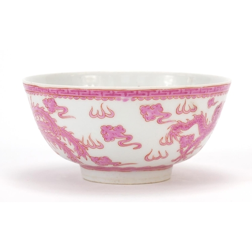 463 - Chinese porcelain bowl hand painted in pink with a dragon and phoenix amongst clouds chasing a flami... 