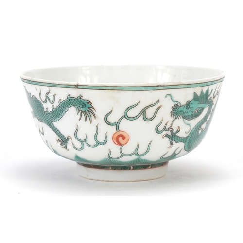 824 - Chinese porcelain bowl hand painted in green and iron red with two dragons chasing a flaming pearl a... 