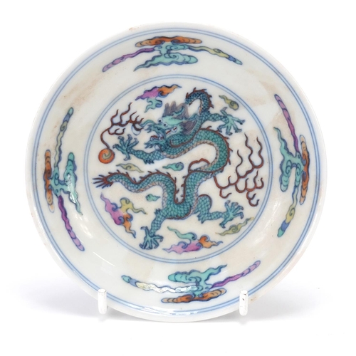 186 - Chinese porcelain doucai dish hand painted with a dragon amongst clouds chasing a flaming pearl, six... 