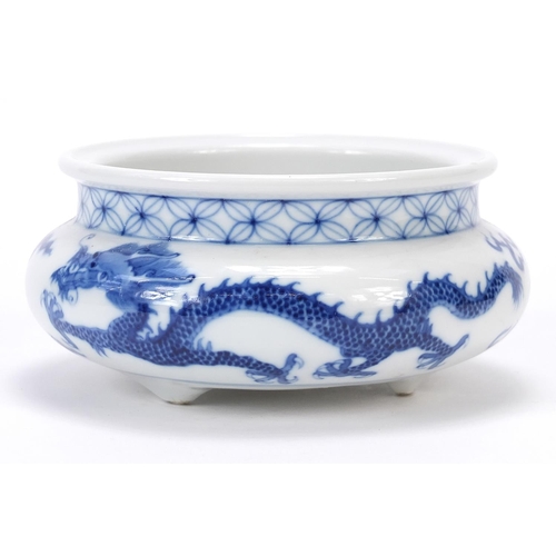 820 - Chinese blue and white porcelain tripod censer hand painted with two dragons chasing a flaming pearl... 