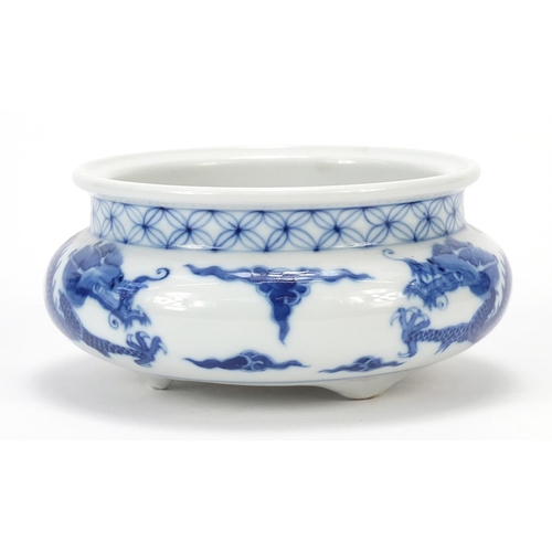 820 - Chinese blue and white porcelain tripod censer hand painted with two dragons chasing a flaming pearl... 