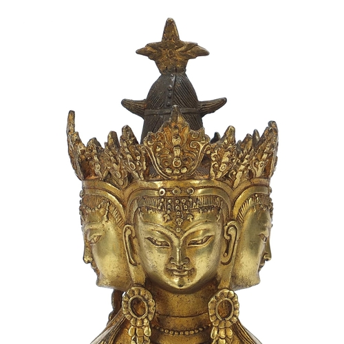 839 - Chino Tibetan gilt bronze figure of four headed Buddha, 31cm high