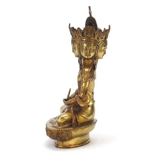 839 - Chino Tibetan gilt bronze figure of four headed Buddha, 31cm high