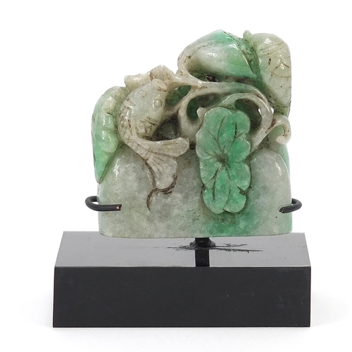 724 - Chinese green jade carving of a fish and flowers on display stand, overall 7cm wide