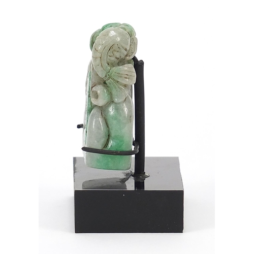 724 - Chinese green jade carving of a fish and flowers on display stand, overall 7cm wide