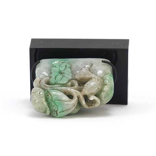 724 - Chinese green jade carving of a fish and flowers on display stand, overall 7cm wide