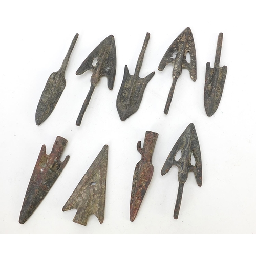 406 - Ten patinated bronze arrow heads, the largest approximately 8cm in length