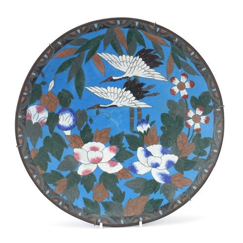 837 - Japanese cloisonné charger enamelled with two cranes amongst flowers, 30cm in diameter