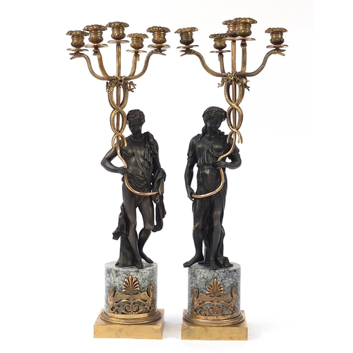 150 - Large pair of classical partially gilt and patinated bronze figural five branch candelabras with mar... 