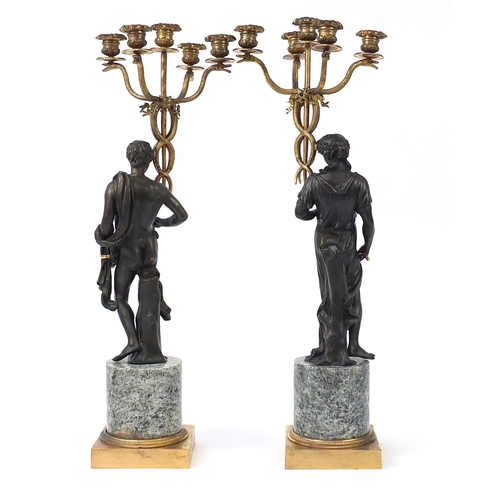 150 - Large pair of classical partially gilt and patinated bronze figural five branch candelabras with mar... 