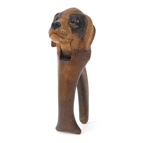 140 - Good pair of Black Forest wooden nutcrackers carved in the form of a dogs with beaded glass eyes, 19... 