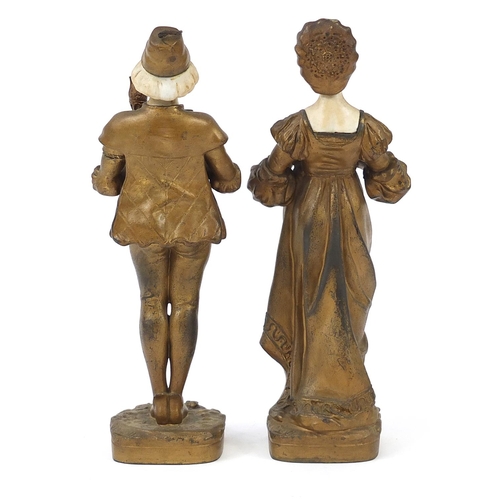 42 - Pair of gilt metal and alabaster figures of a boy and girl in dutch dress, the largest 28.5cm high