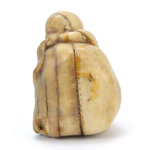 205 - ** WITHDRAWN ** Japanese carved ivory netsuke of a man and figure hiding, character marks to the und... 