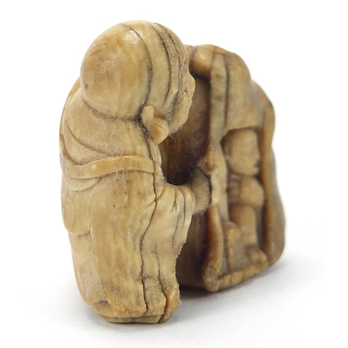 205 - ** WITHDRAWN ** Japanese carved ivory netsuke of a man and figure hiding, character marks to the und... 