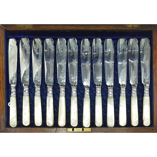 1083 - Oak twelve place canteen of silver plated fish knives and forks with mother of pearl handles, the ca... 