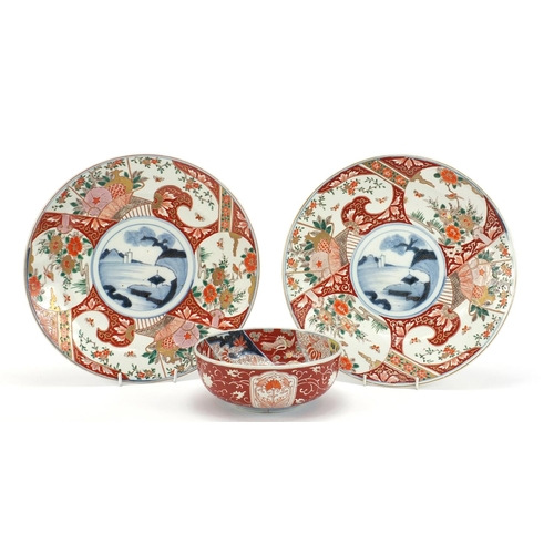 283 - Japanese Imari comprising a pair of chargers hand painted with flowers and landscapes and a bowl, th... 