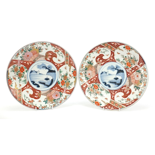 283 - Japanese Imari comprising a pair of chargers hand painted with flowers and landscapes and a bowl, th... 