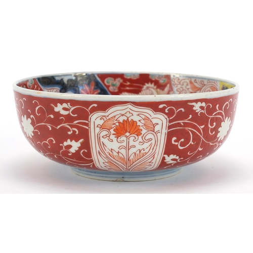 283 - Japanese Imari comprising a pair of chargers hand painted with flowers and landscapes and a bowl, th... 