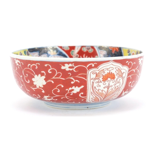 283 - Japanese Imari comprising a pair of chargers hand painted with flowers and landscapes and a bowl, th... 