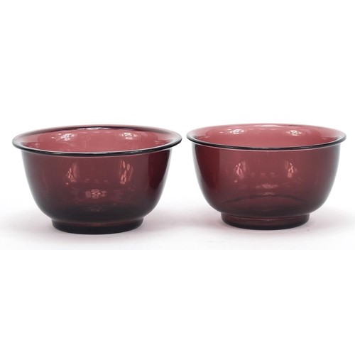 278 - Near pair of Chinese purple Peking glass bowls, the largest 11cm in diameter