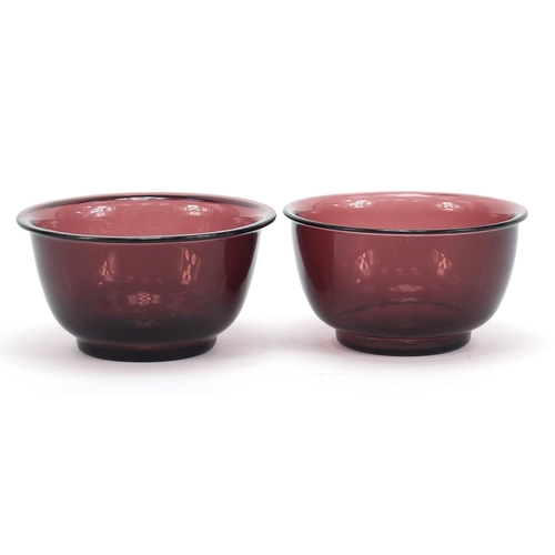 278 - Near pair of Chinese purple Peking glass bowls, the largest 11cm in diameter