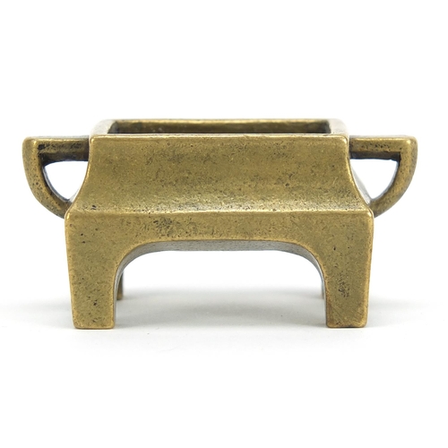 476 - Chinese miniature patinated bronze four footed censer with twin handles, character marks to the base... 