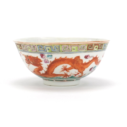 275 - Chinese porcelain bowl hand painted in the famille rose palette with a dragon and phoenix chasing a ... 