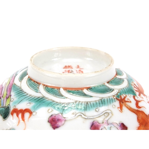 275 - Chinese porcelain bowl hand painted in the famille rose palette with a dragon and phoenix chasing a ... 