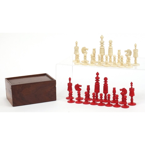 139 - Carved bone half stained chess set with mahogany case, the largest pieces each 9cm high