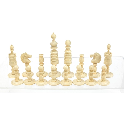 139 - Carved bone half stained chess set with mahogany case, the largest pieces each 9cm high