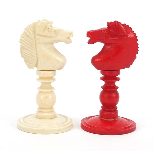 139 - Carved bone half stained chess set with mahogany case, the largest pieces each 9cm high