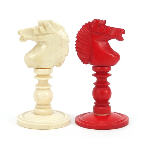 139 - Carved bone half stained chess set with mahogany case, the largest pieces each 9cm high