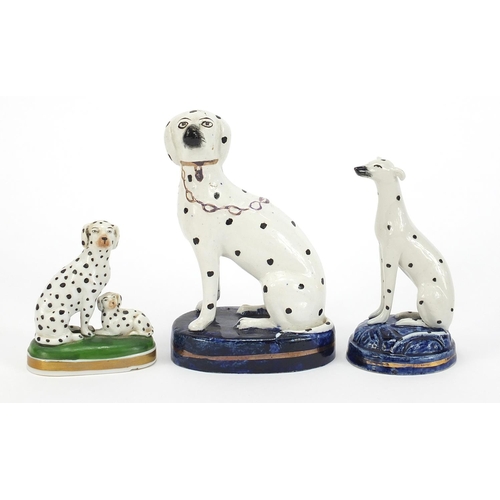 72 - Two Staffordshire pottery Dalmatians and one other, the largest 13cm high