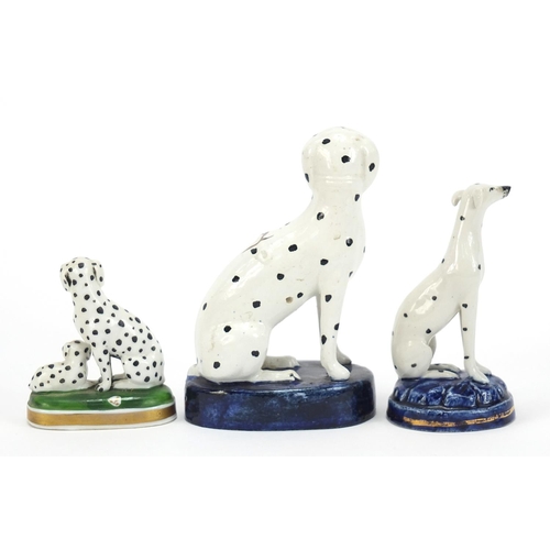 72 - Two Staffordshire pottery Dalmatians and one other, the largest 13cm high