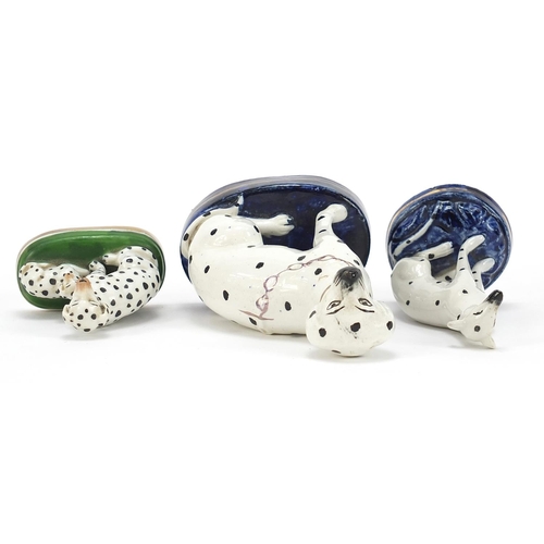 72 - Two Staffordshire pottery Dalmatians and one other, the largest 13cm high