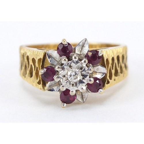 851 - 18ct gold diamond and ruby flower head ring, size N, 6.8g