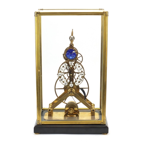 856 - Gothic style brass skeleton clock with moon face dial and glass display case, with key and pendulum,... 