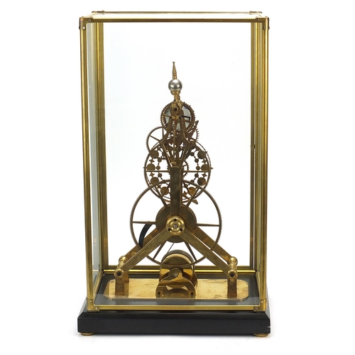 856 - Gothic style brass skeleton clock with moon face dial and glass display case, with key and pendulum,... 