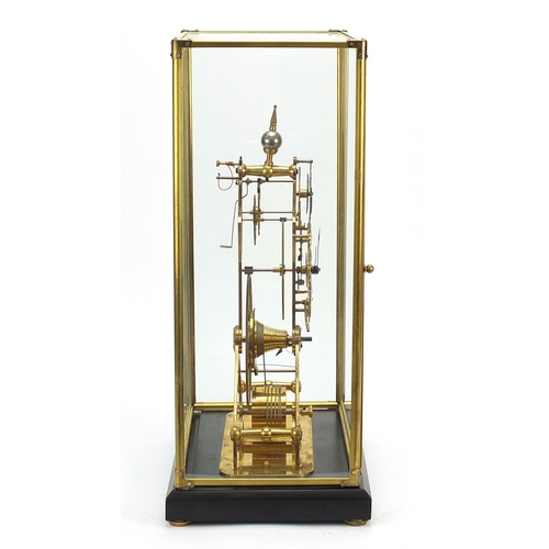 856 - Gothic style brass skeleton clock with moon face dial and glass display case, with key and pendulum,... 