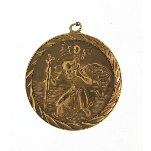 1110 - 9ct gold St Christopher pendant, 18mm in diameter, 1.7g