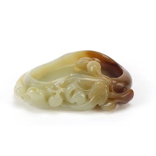 478 - Chinese naturalistic celadon and russet jade brush washer carved with a water dragon, 8.5cm wide