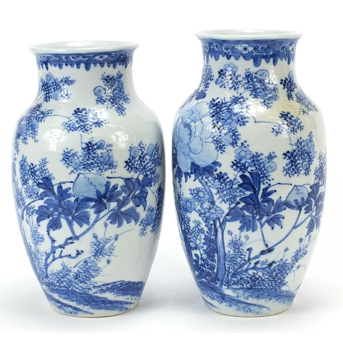 1000 - Matched pair of Japanese blue and white porcelain vases hand painted with flowers, each 26cm high