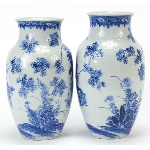 1000 - Matched pair of Japanese blue and white porcelain vases hand painted with flowers, each 26cm high