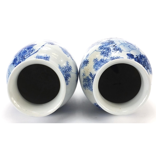 1000 - Matched pair of Japanese blue and white porcelain vases hand painted with flowers, each 26cm high