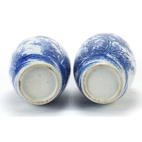 1000 - Matched pair of Japanese blue and white porcelain vases hand painted with flowers, each 26cm high