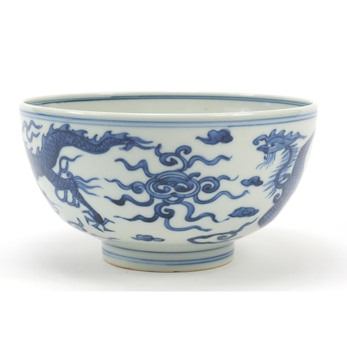 994 - Chinese blue and white porcelain bowl hand painted with a dragon and phoenix amongst clouds chasing ... 