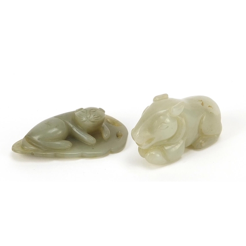 566 - Two Chinese celadon jade carvings including one of a lion on leaf, the largest 5.5cm wide