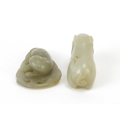 566 - Two Chinese celadon jade carvings including one of a lion on leaf, the largest 5.5cm wide